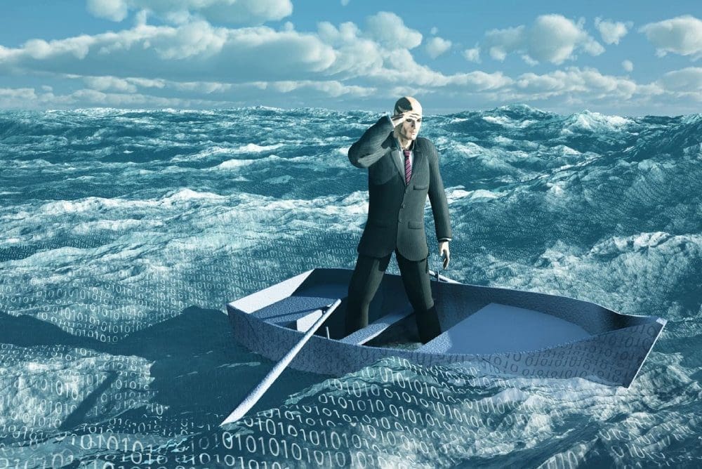 A man in a suit and tie standing on the back of a boat.