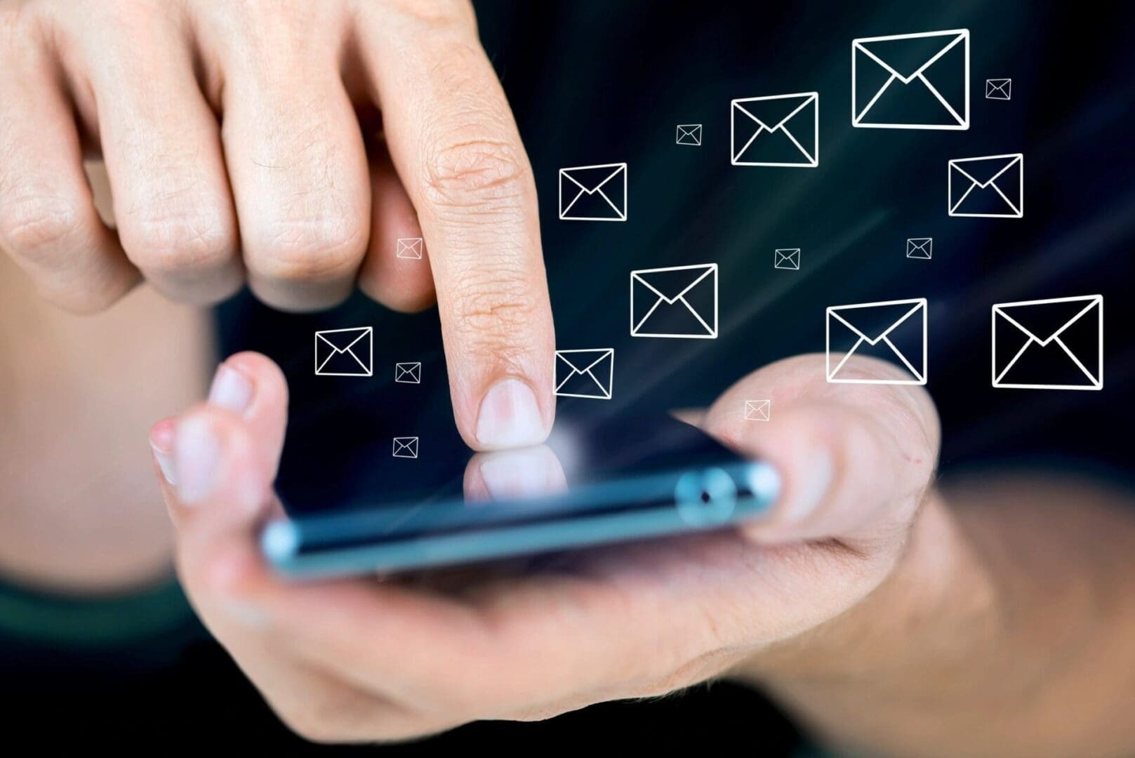 fmf5538 A person is using their phone with email icons above them.